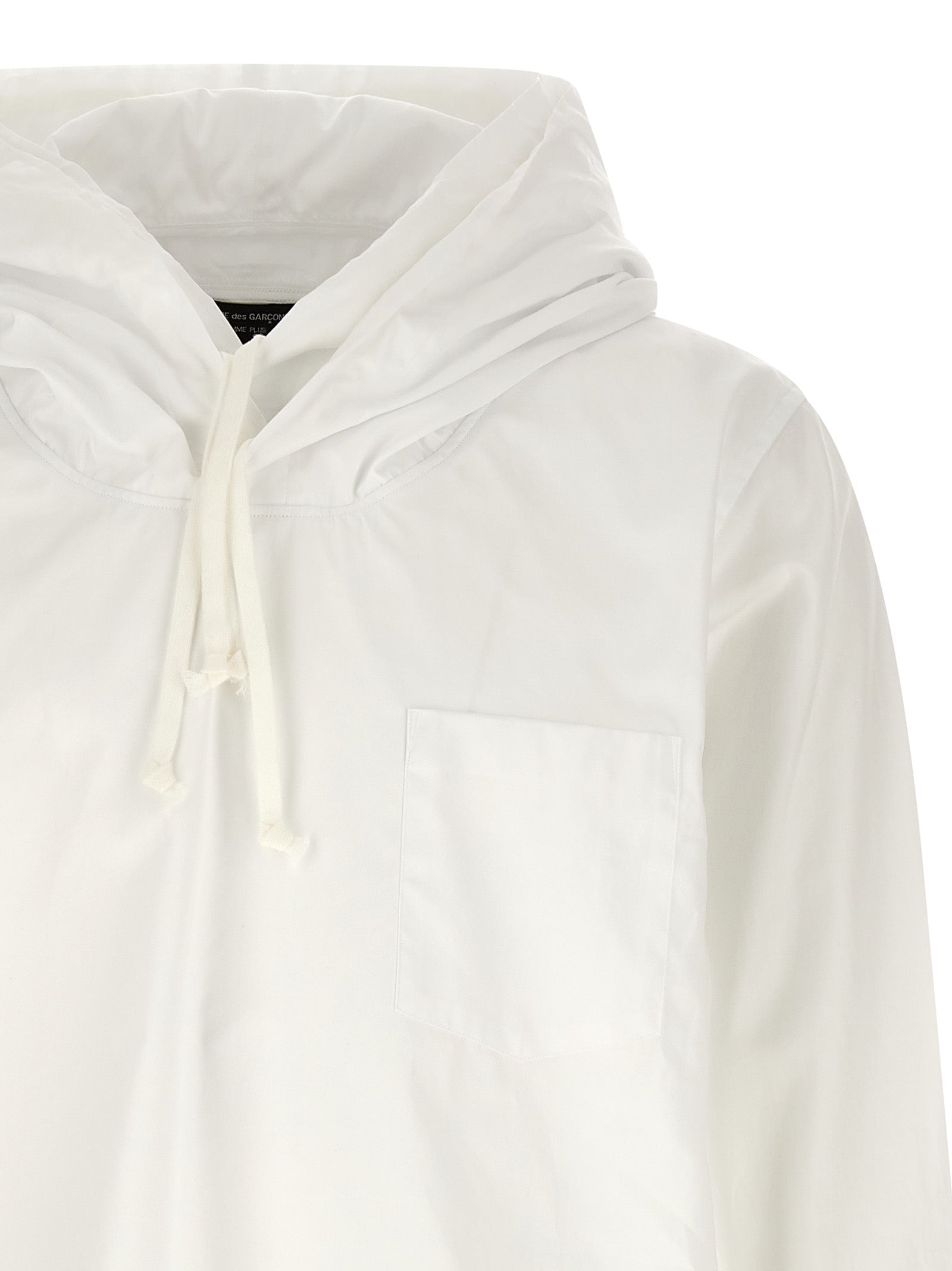 Elevate your style with the Comme Des Garçons White Cotton Blouse, a masterpiece of avant-garde luxury, featuring exquisite craftsmanship and timeless elegance for the discerning individual.