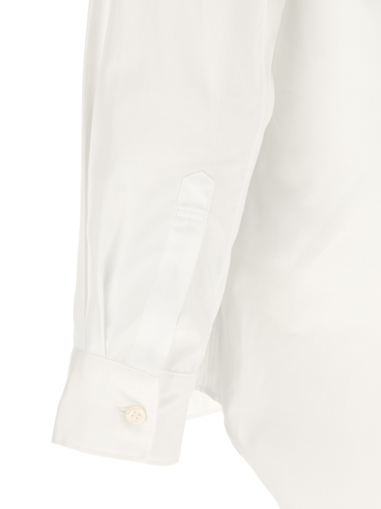 Elevate your wardrobe with the Comme Des Garçons White Cotton Blouse, a masterpiece of avant-garde luxury crafted from 100% cotton, perfect for any occasion.