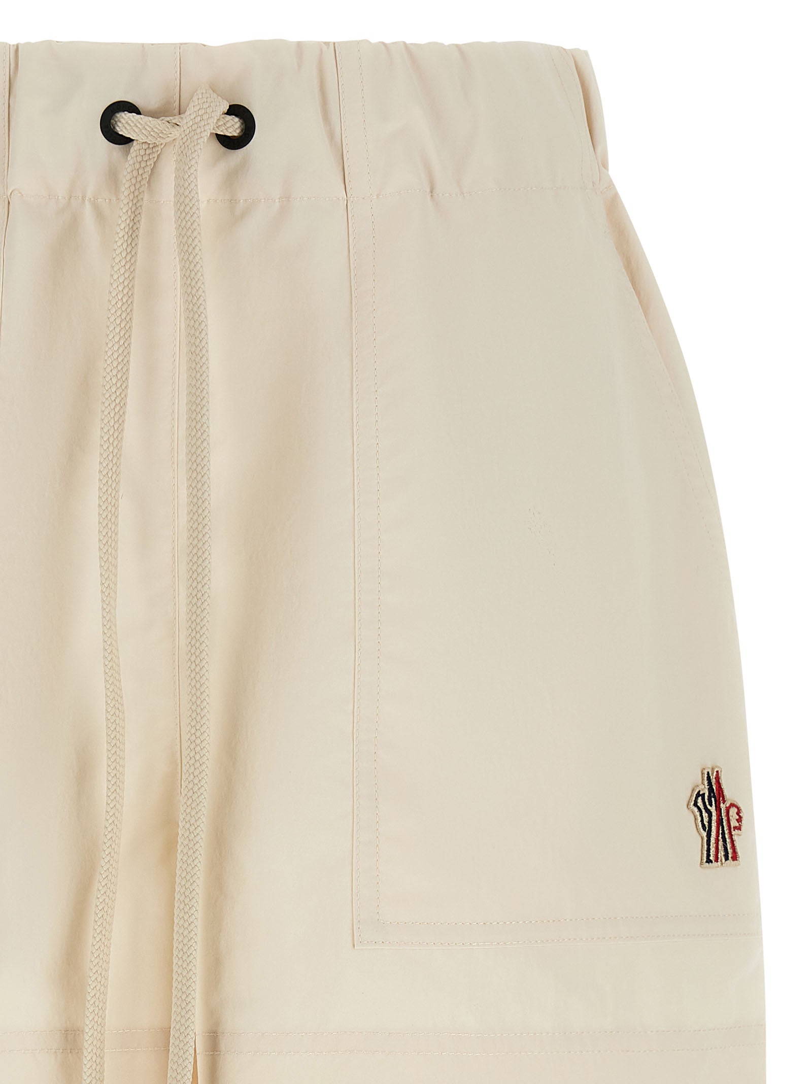 Elevate your summer wardrobe with Moncler Grenoble Bermuda Shorts, crafted from luxurious 100% polyester, blending sophistication and practicality for the discerning individual.