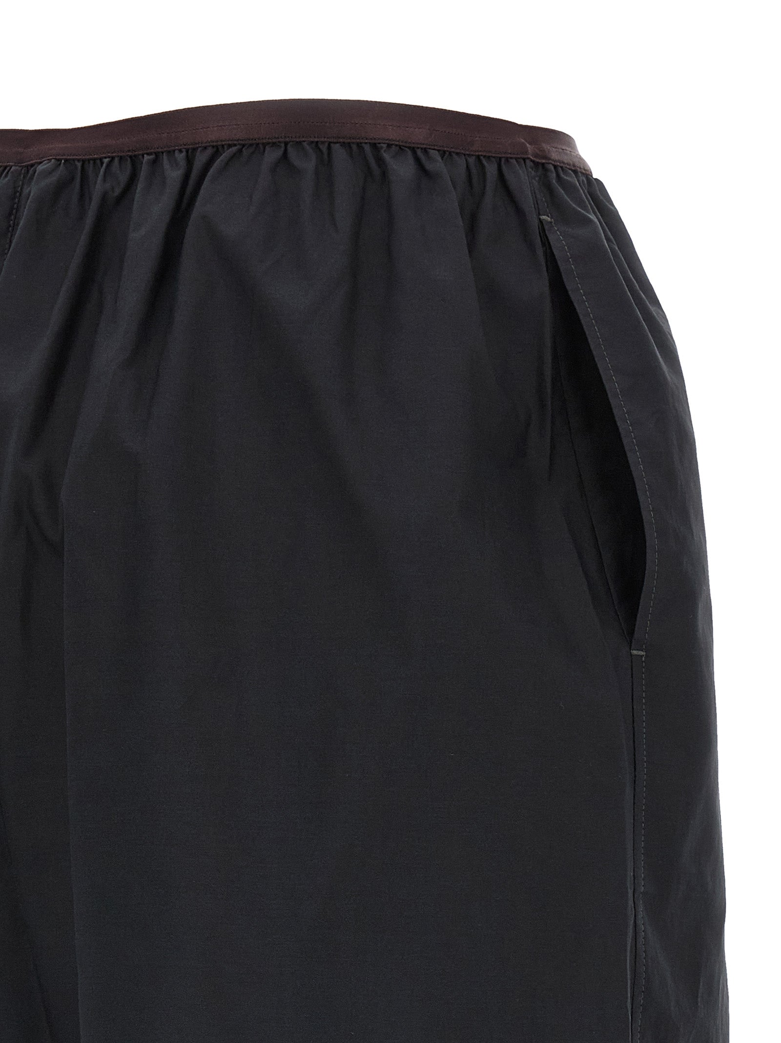 Indulge in the exquisite Lemaire Gray Cotton Bermuda Shorts, a blend of cotton and silk that redefines luxury with a chic wide-leg silhouette and elegant design.