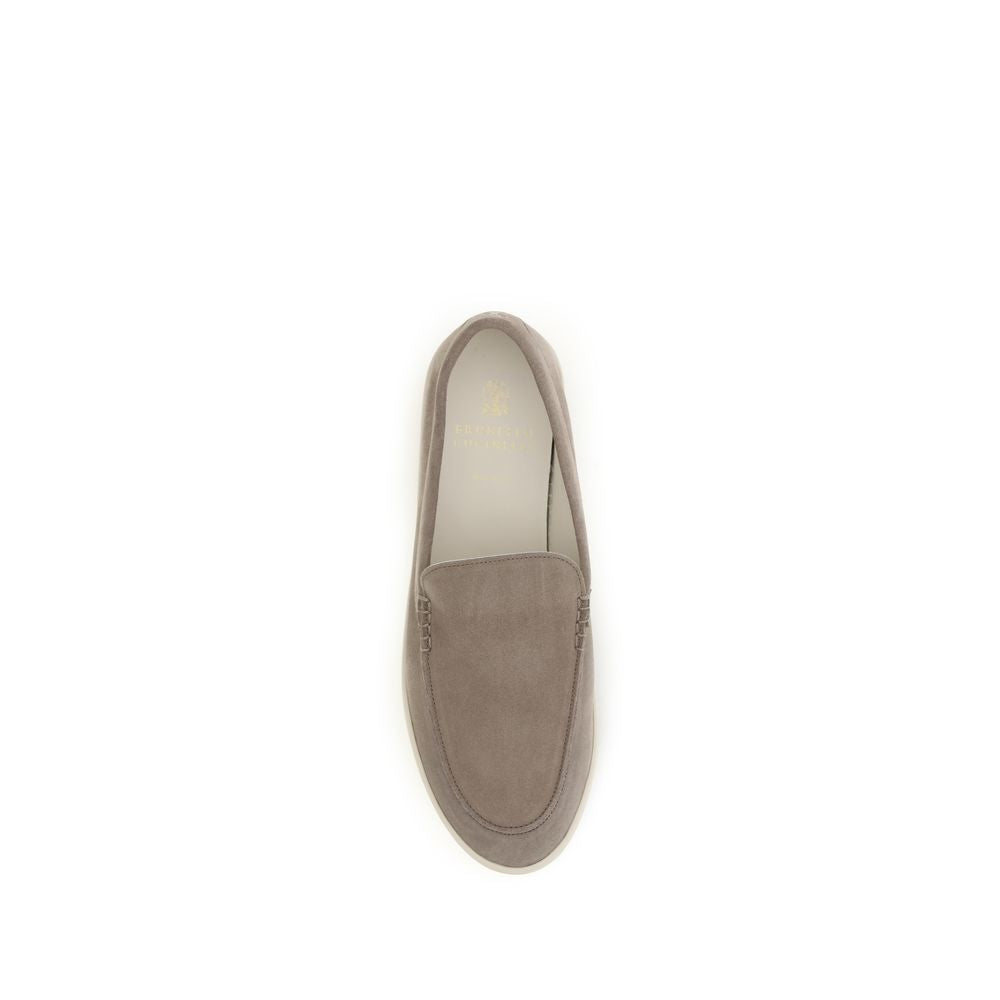 Indulge in the Brunello Cucinelli Gray Calf Leather Bos Taurus Slip-On Loafers, where exquisite craftsmanship meets timeless elegance, perfect for the discerning connoisseur.