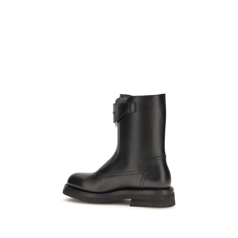Step into a realm of luxury with Alexander McQueen's Black Calf Leather Bos Taurus Lace-Up Boots, where exquisite craftsmanship meets bold elegance for the discerning individual.