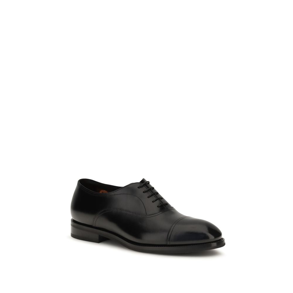 Experience the allure of Santoni's Black Calf Leather Bos Taurus Oxfords, where exquisite craftsmanship meets timeless elegance, perfect for the discerning individual.