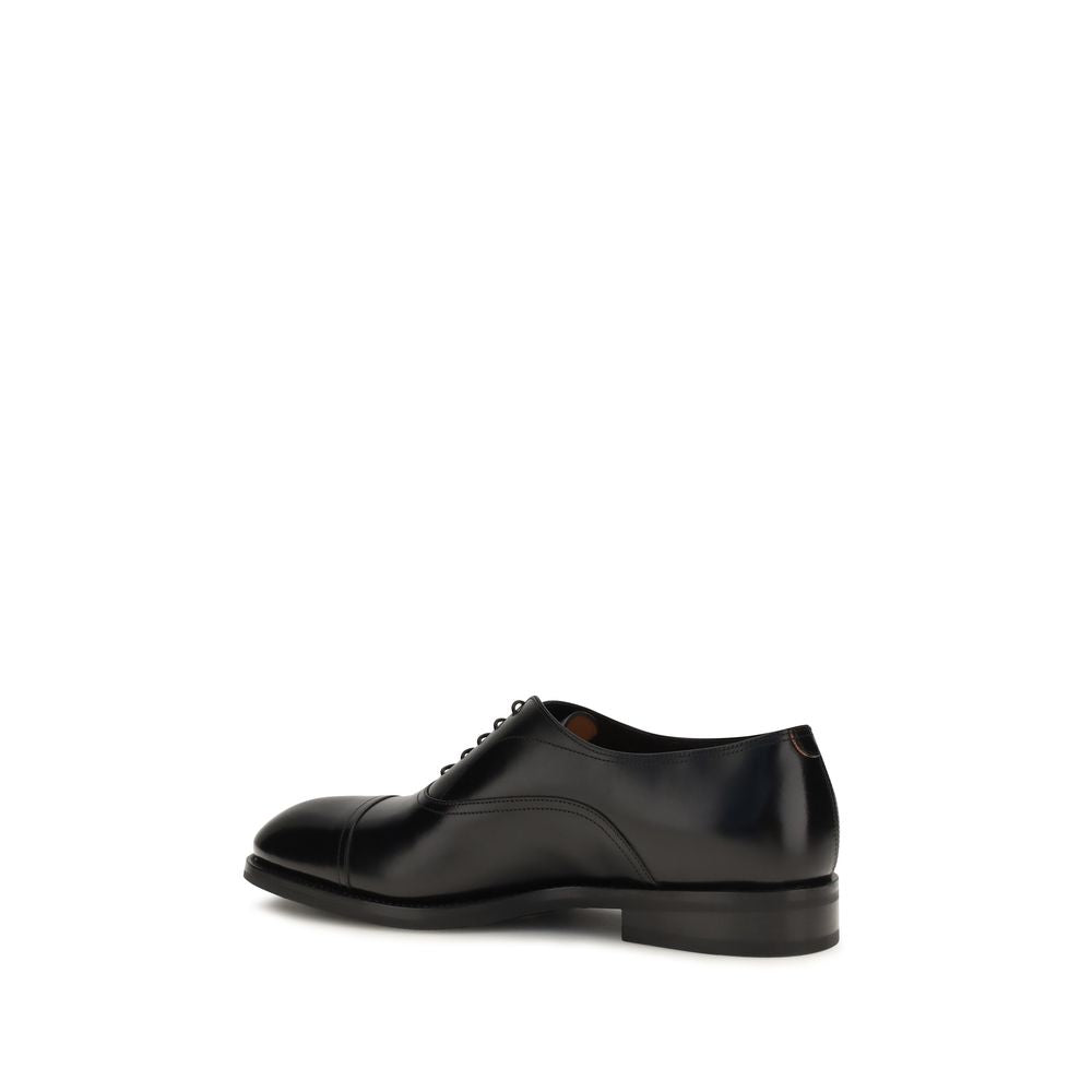 Experience the exquisite elegance of Santoni Black Calf Leather Bos Taurus Oxfords, crafted from luxurious calfskin for the discerning individual who values timeless sophistication.