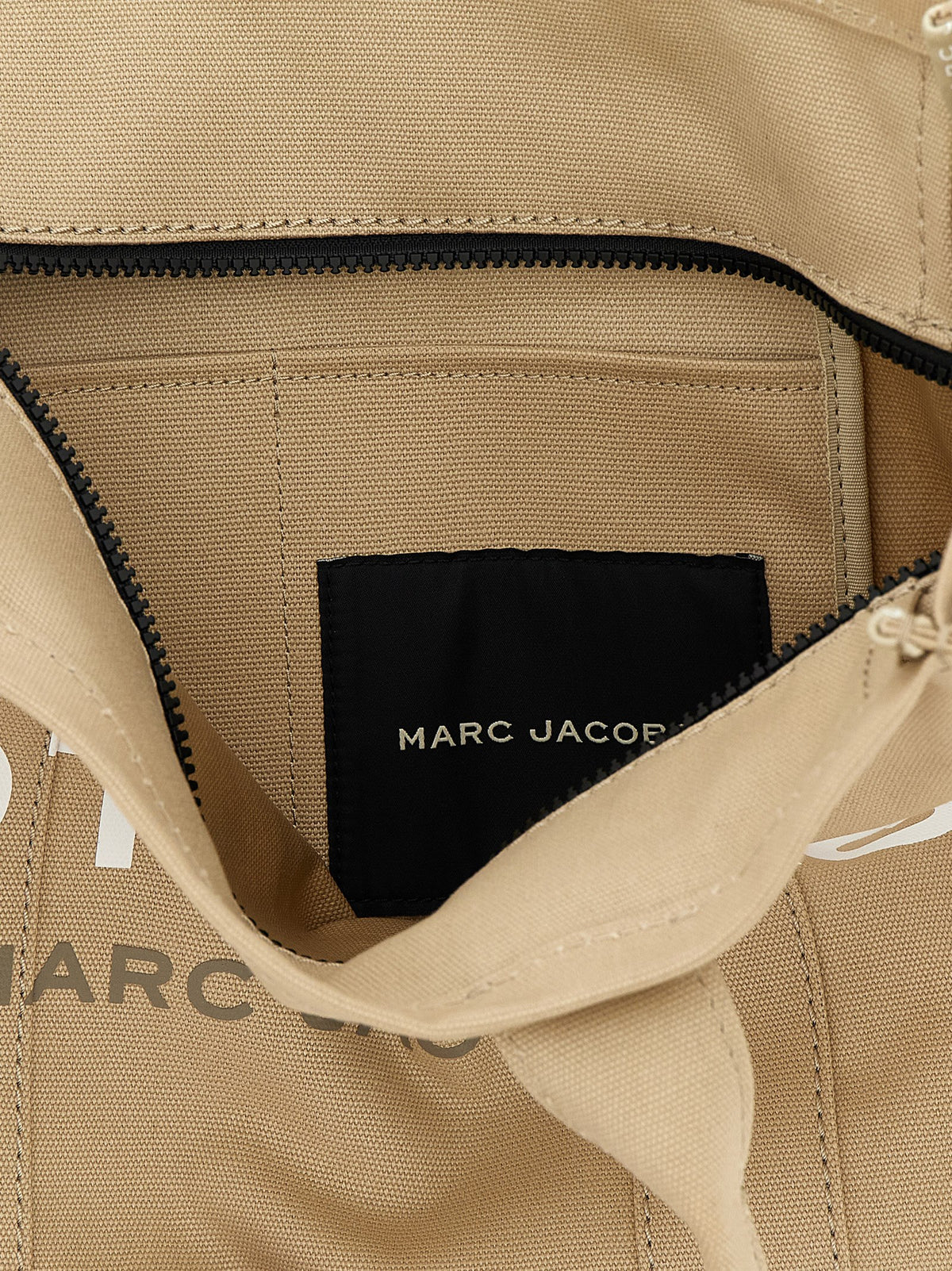 Discover the Marc Jacobs Beige Cotton Tote Bag from the Canvas Large Tote collection, a masterpiece of artisanal luxury that embodies sophistication and timeless elegance.