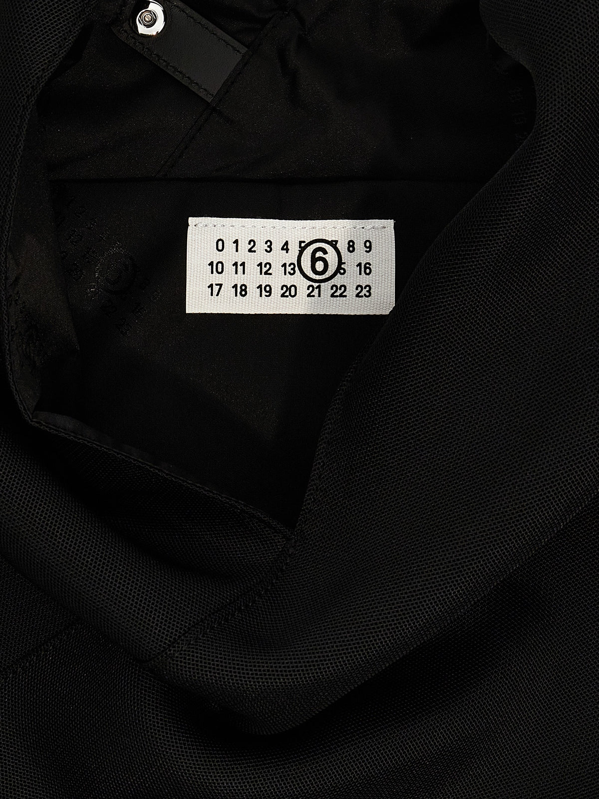 Discover the MM6 Maison Margiela Black Polyester Shoulder Bag, an emblem of artisanal luxury that elevates your style with avant-garde sophistication and timeless elegance.