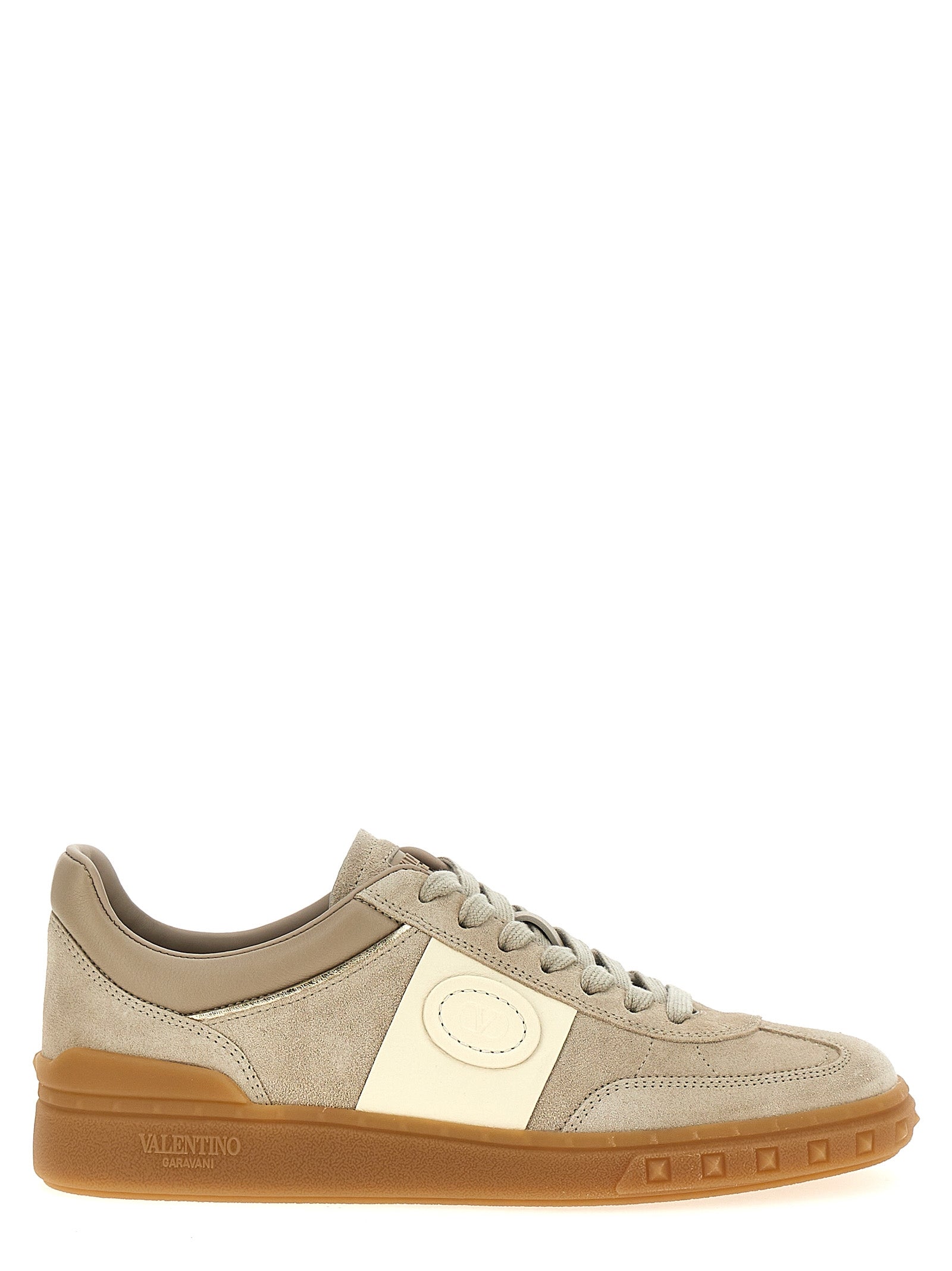 Elevate your style with Valentino Garavani's Beige Calfskin Low Top Sneakers, where exquisite craftsmanship meets luxurious design for the discerning individual.