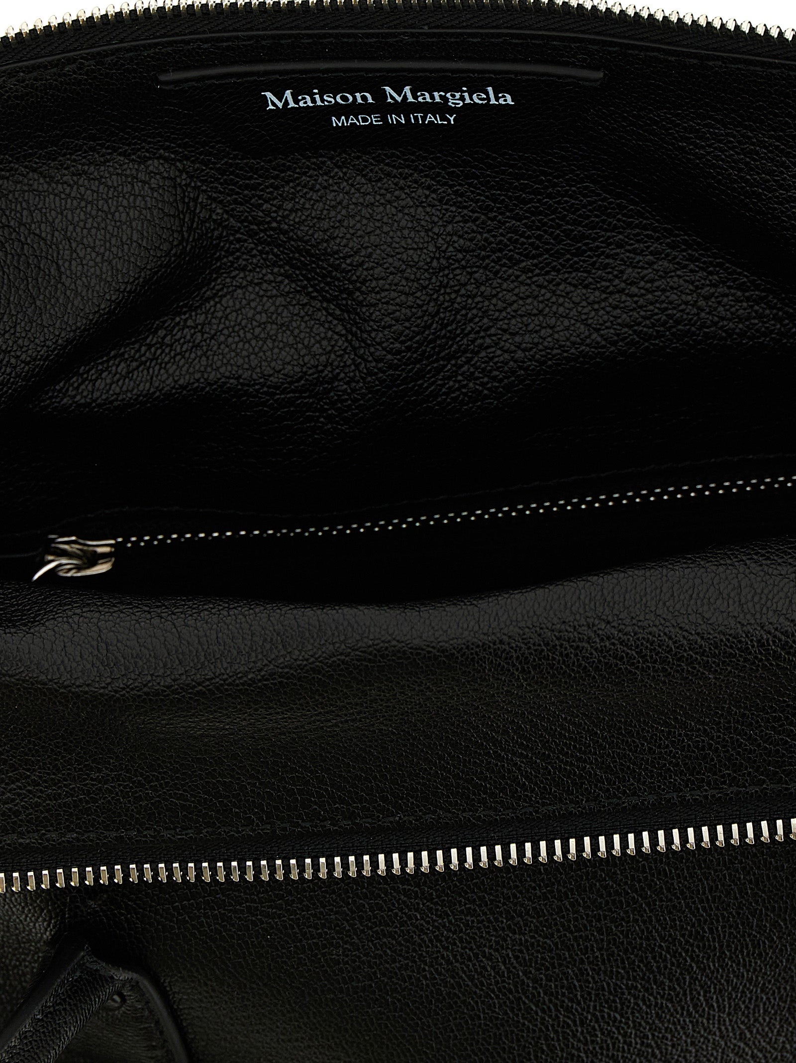 Discover the Maison Margiela Black Cashmere Handbag, a timeless luxury crafted from sumptuous hammered leather, epitomizing elegance and sophistication for every occasion.