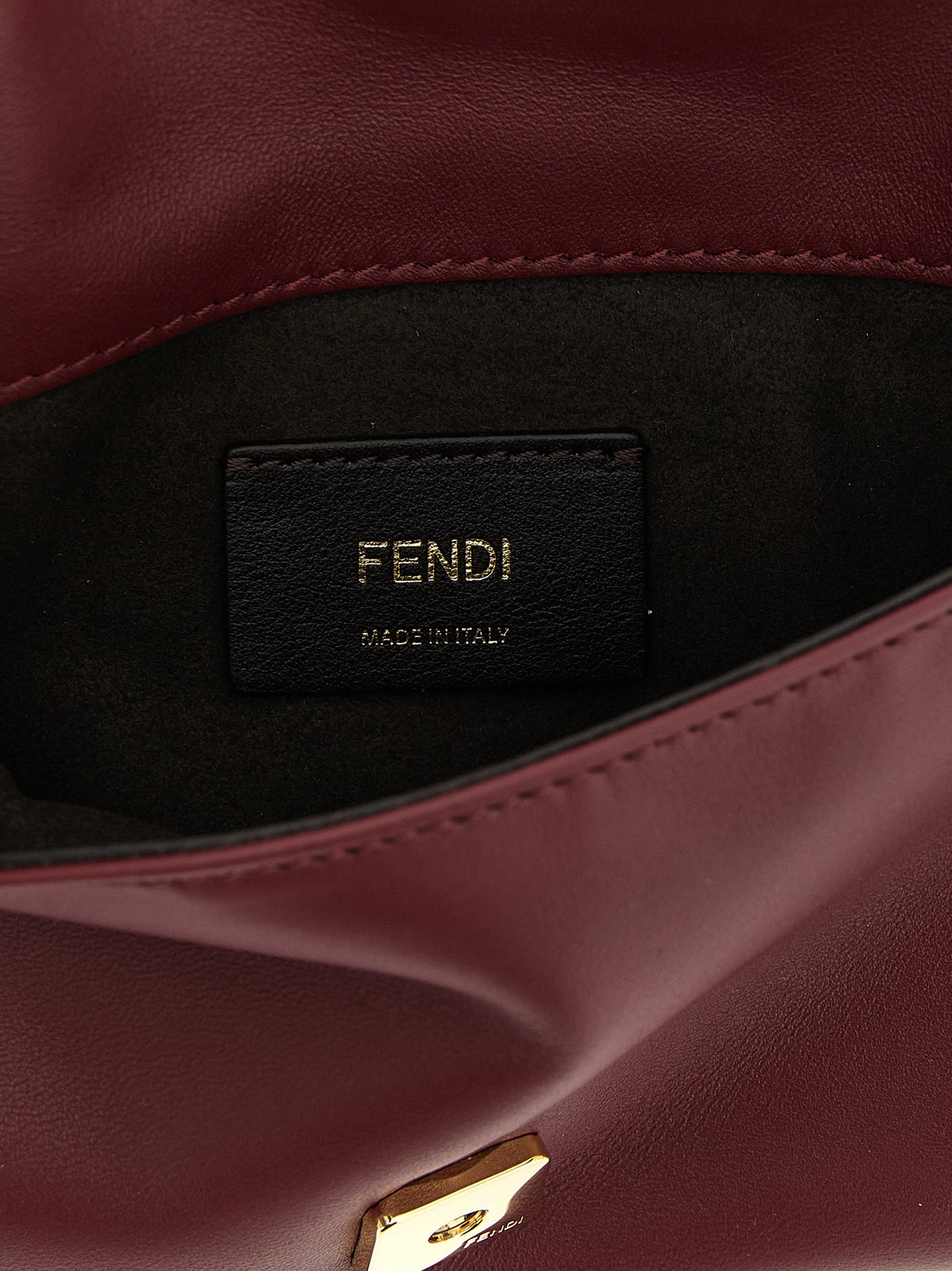Discover the Fendi Bordeaux Lamb Leather Clutch Bag, a masterpiece of Italian craftsmanship that embodies timeless elegance and sophistication for any occasion.