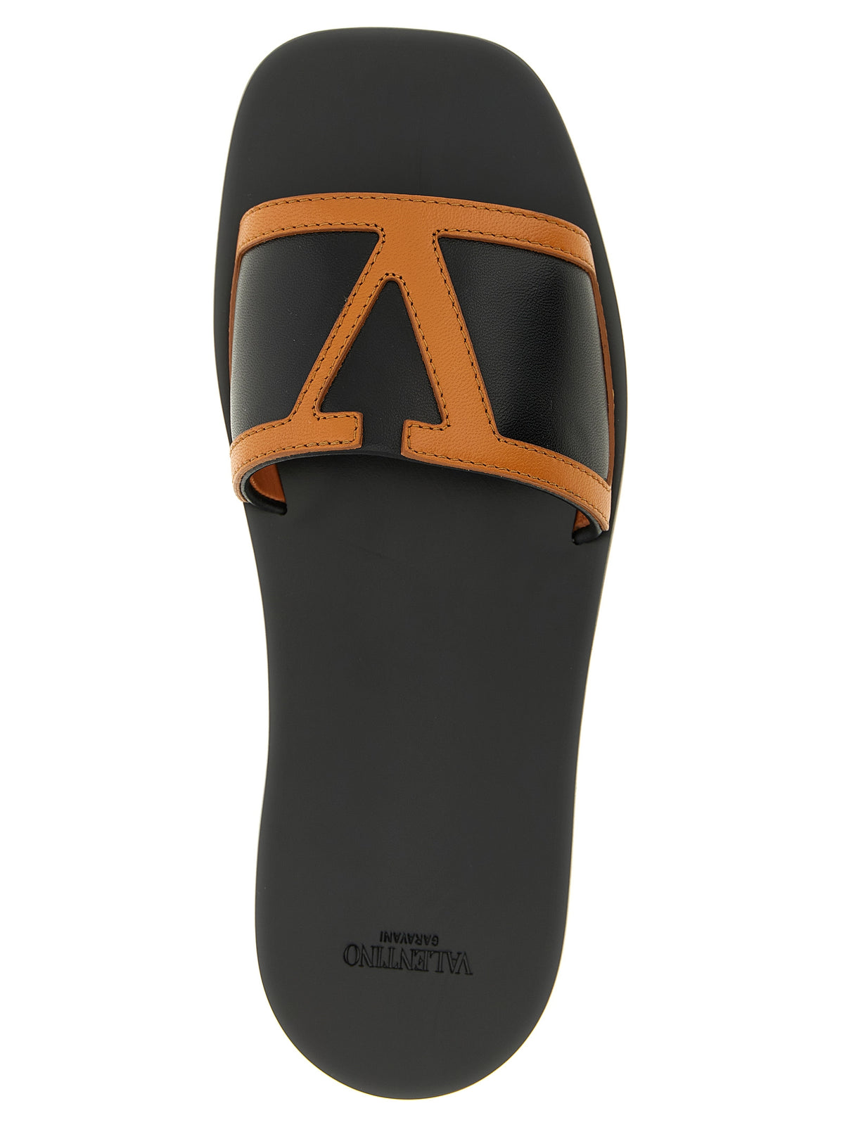 Indulge in the exquisite Valentino Garavani Brown Lamb Leather Slides, where luxurious craftsmanship meets effortless elegance, perfect for the discerning fashion connoisseur.