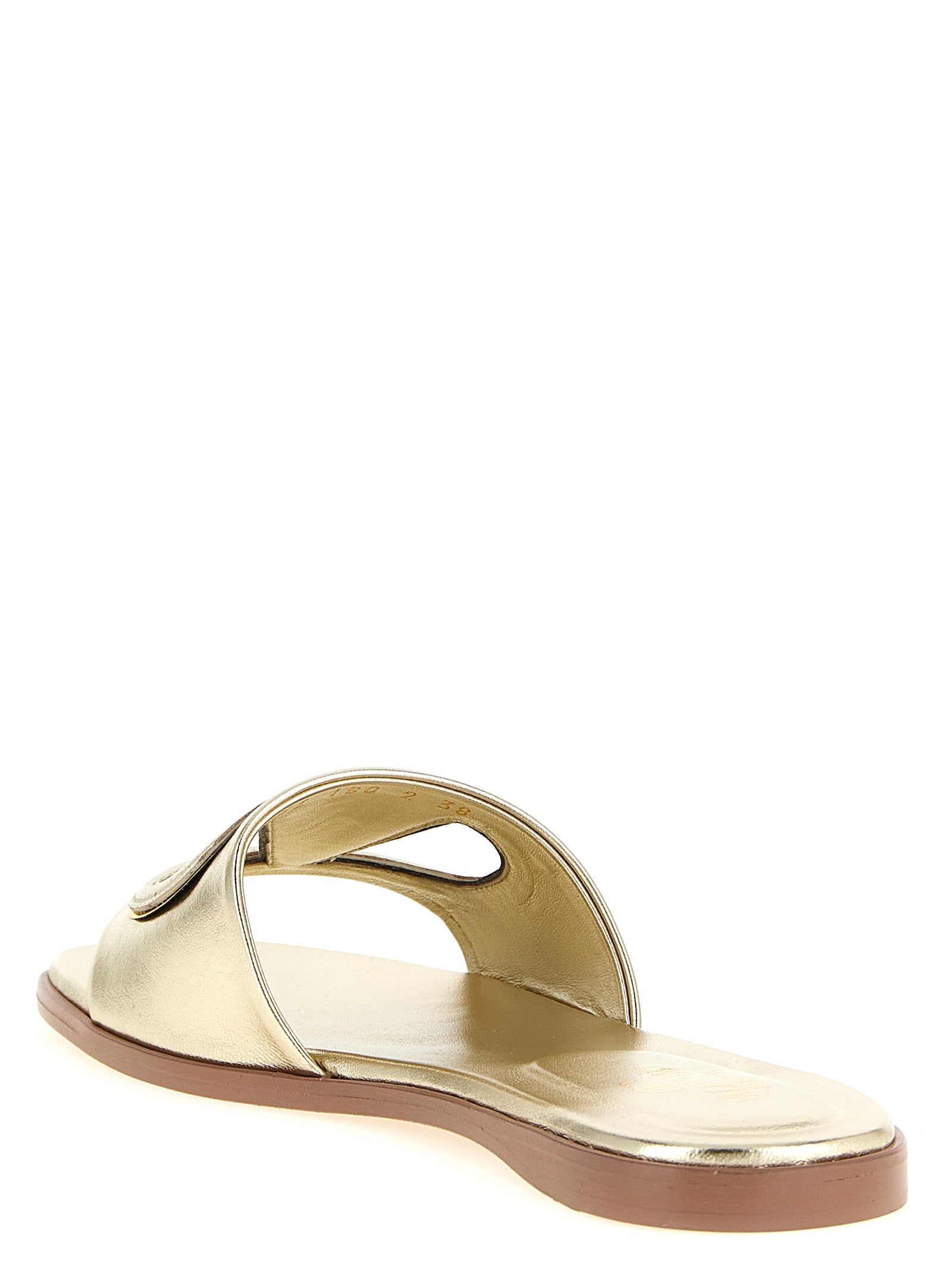 Indulge in the opulent allure of Valentino Garavani Gold Calfskin Slides, crafted from luxurious calfskin leather in Italy, embodying timeless elegance and sophistication.