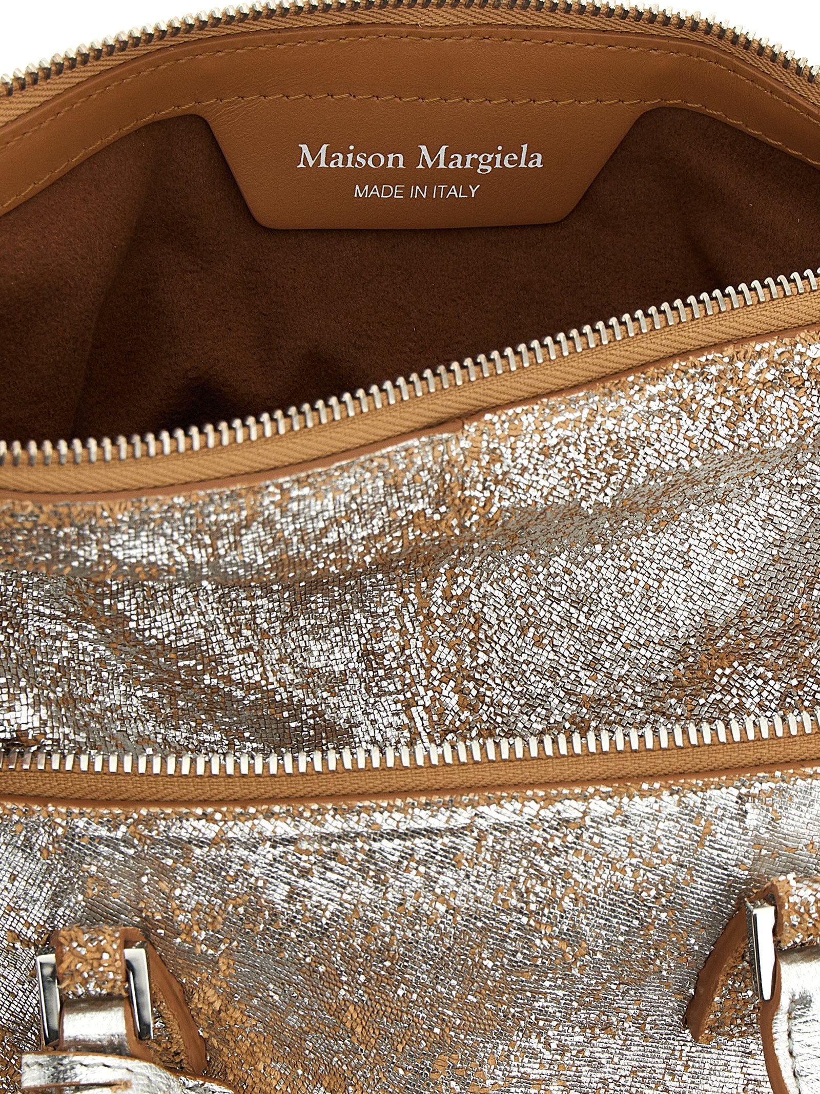 Discover the Maison Margiela Silver Lambskin Handbag, a luxurious statement piece crafted from 100% sheepskin leather, embodying Italian artisan craftsmanship and modern elegance.