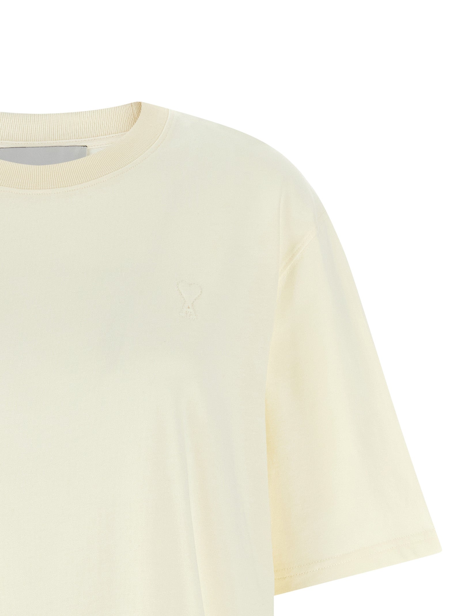 Indulge in the elegance of the Ami Paris White Cotton T-Shirt, a luxurious staple crafted from premium cotton, embodying contemporary sophistication for the discerning individual.