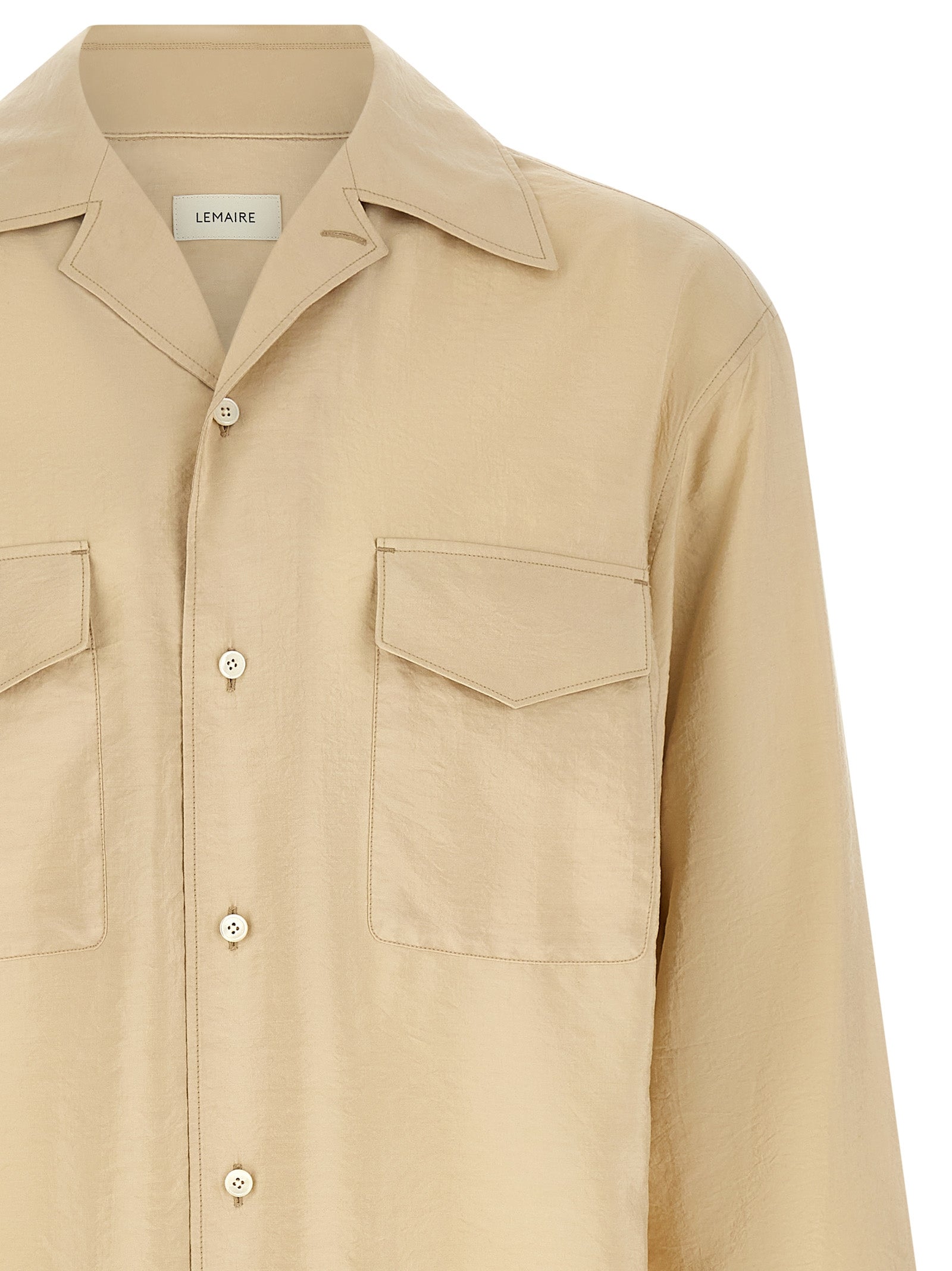Discover the Lemaire Beige Silk Blouse, a luxurious blend of silk and polyamide, embodying avant-garde elegance and timeless sophistication for the discerning wardrobe.