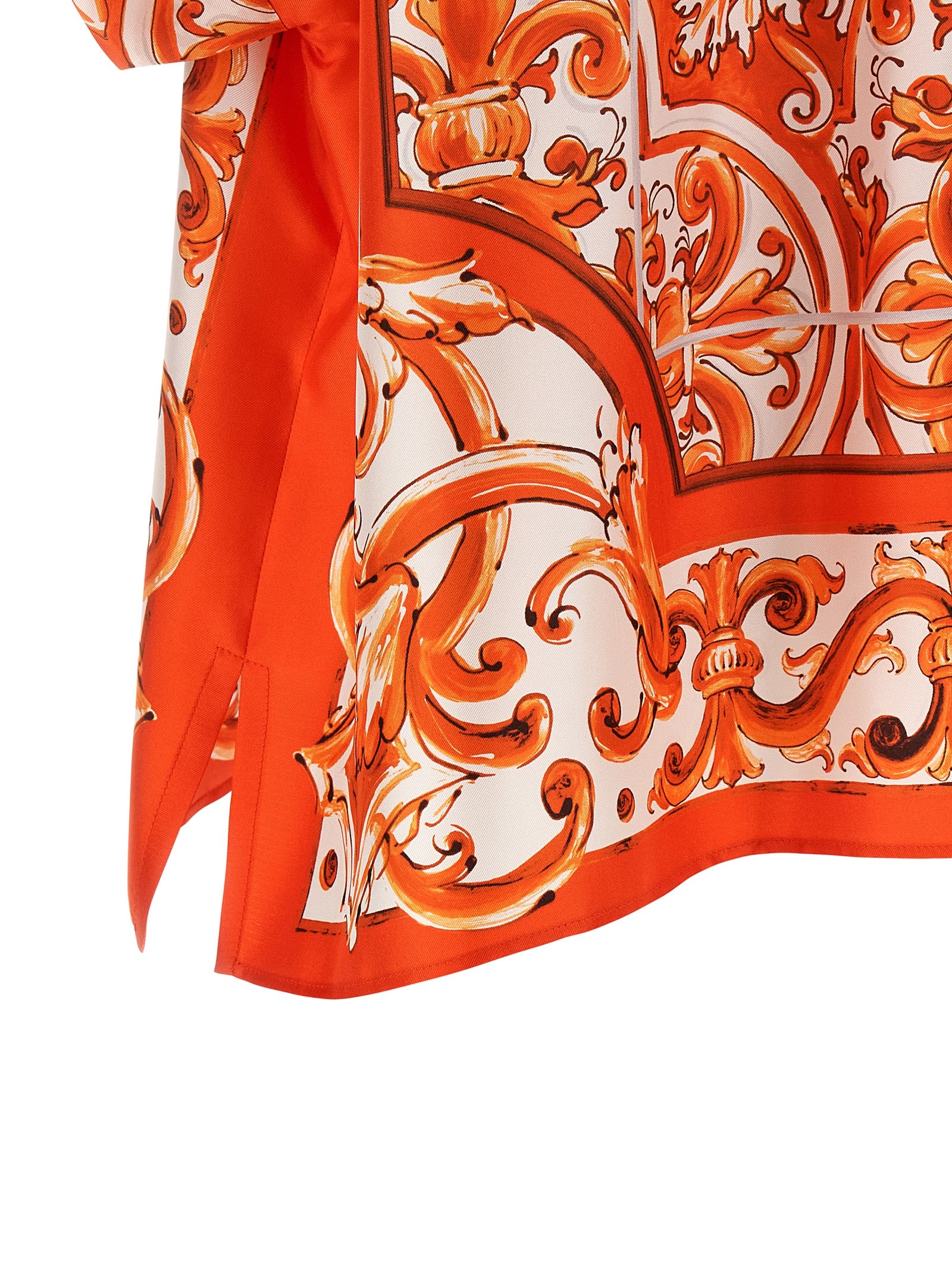 Indulge in the exquisite Dolce & Gabbana Orange Silk Blouse, a masterpiece of Italian craftsmanship that embodies elegance and sophistication for the discerning individual.