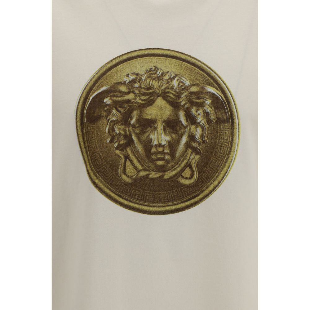 Elevate your wardrobe with the Versace Beige Cotton T-Shirt, a luxurious blend of comfort and style, featuring an iconic Medusa Coin graphic for timeless sophistication.