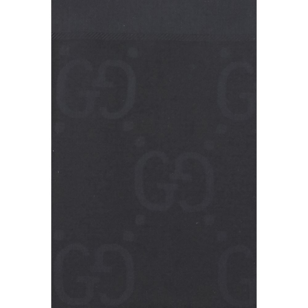Experience the allure of the Gucci Black Wool Oves Aries Scarf, a luxurious blend of wool and silk, showcasing exquisite jacquard craftsmanship for timeless elegance.
