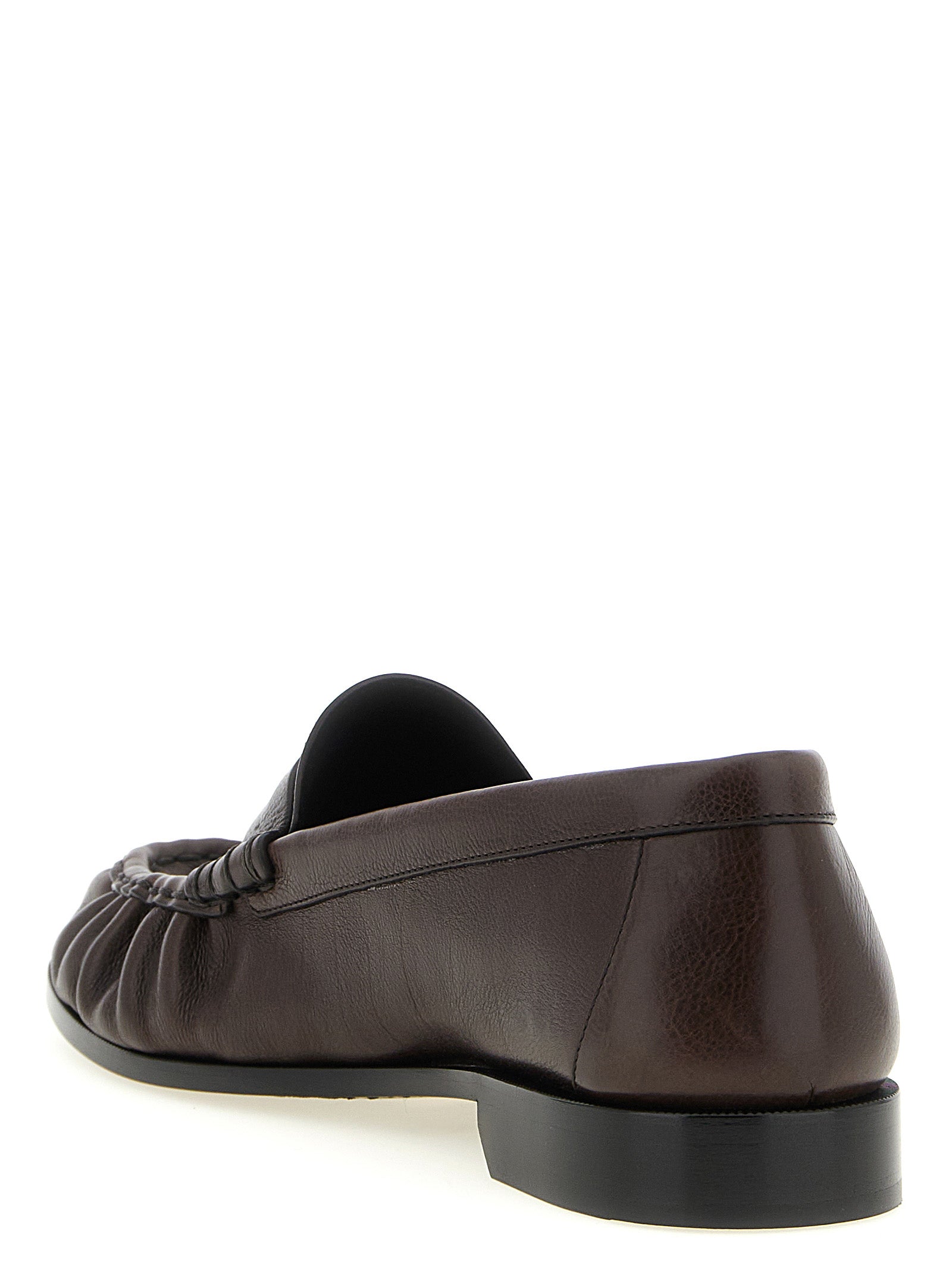 Experience the allure of Saint Laurent's Brown Calfskin Slip-On Loafers, where exquisite craftsmanship meets timeless elegance, perfect for the discerning connoisseur.