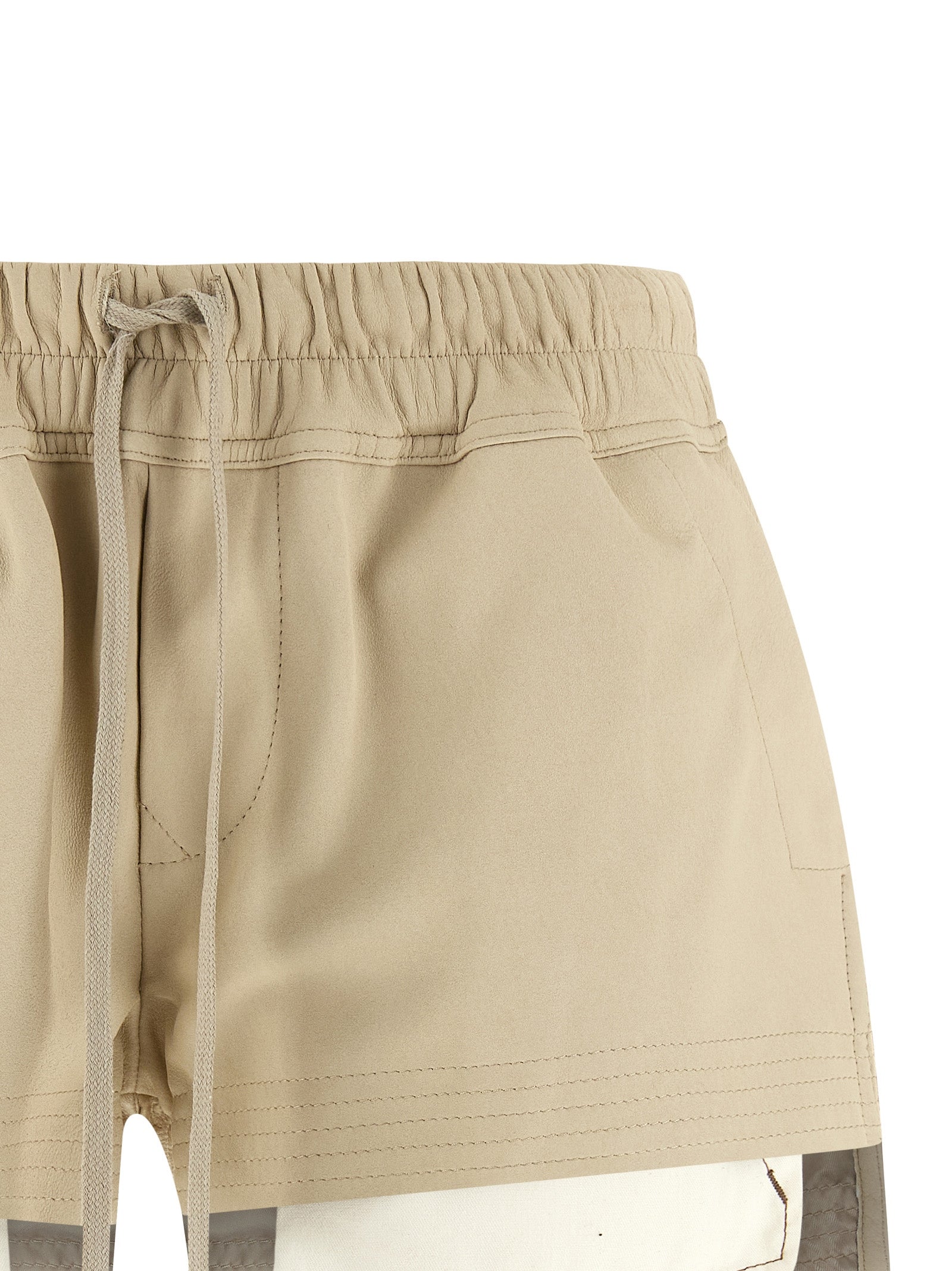Elevate your wardrobe with Rick Owens' exclusive Beige Lamb Leather Bermuda Shorts, a masterpiece of luxurious craftsmanship that redefines contemporary elegance.