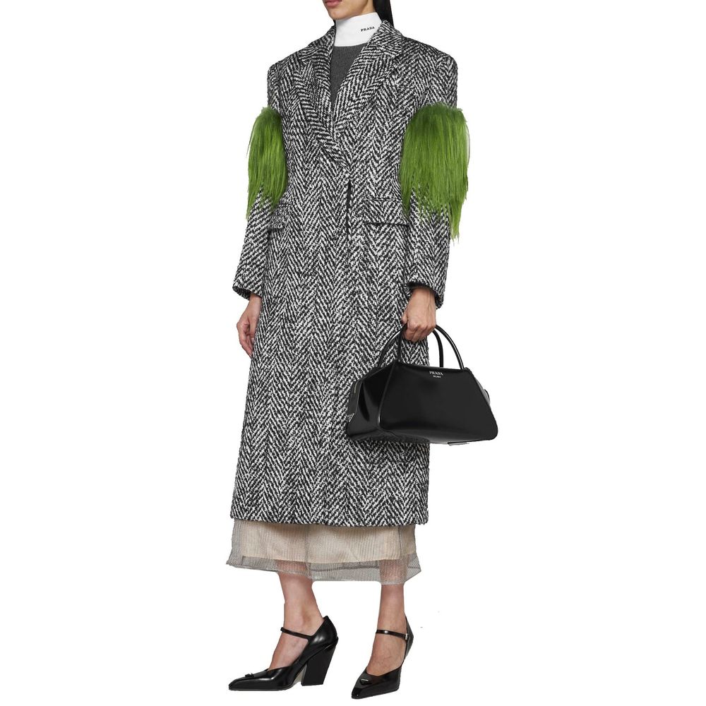 Indulge in the exquisite Prada Gray Wool Coat, a masterpiece of herringbone elegance, crafted from premium wool and Mohair, embodying timeless luxury and sophistication.
