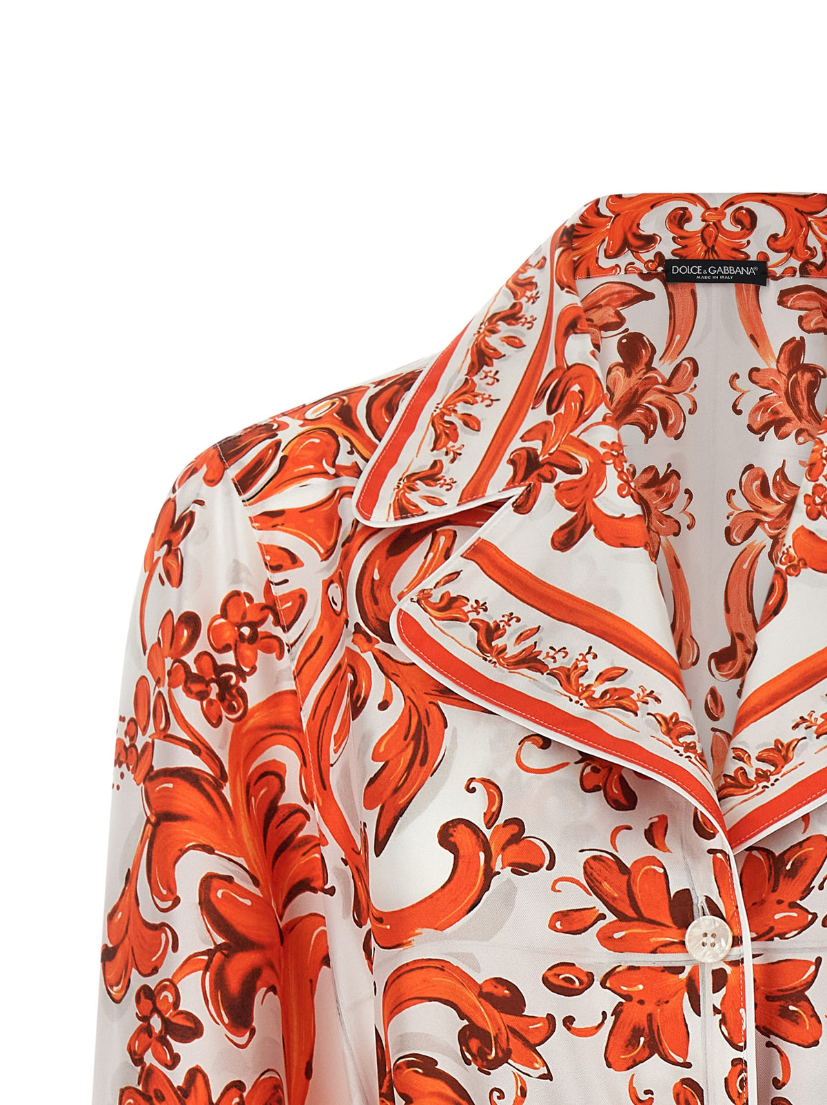 Indulge in the exquisite Dolce & Gabbana Orange Silk Blouse, a masterpiece of Italian craftsmanship that embodies luxury and sophistication for the discerning individual.