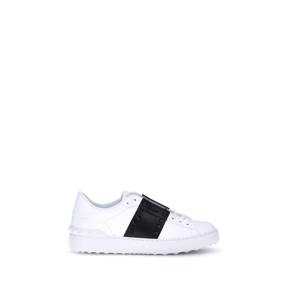 Indulge in the exquisite craftsmanship of Valentino Garavani's White Calf Leather Bos Taurus Low Top Sneakers, where luxury meets bold elegance for the discerning individual.