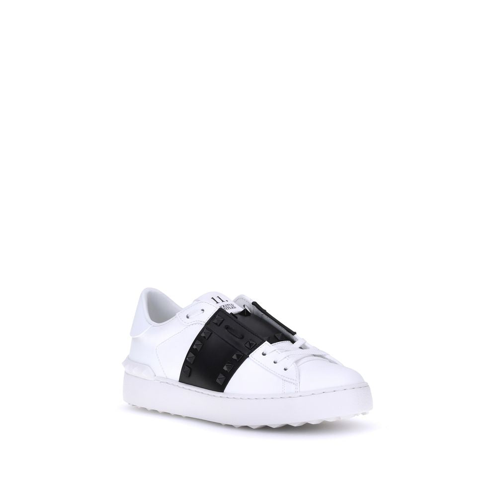 Elevate your style with Valentino Garavani's White Calf Leather Bos Taurus Low Top Sneakers, where exquisite craftsmanship meets bold elegance for the discerning individual.
