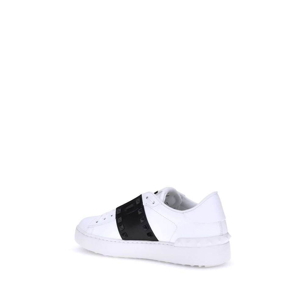 Elevate your style with Valentino Garavani's White Calf Leather Bos Taurus Low Top Sneakers, where exquisite craftsmanship meets bold elegance for the discerning individual.
