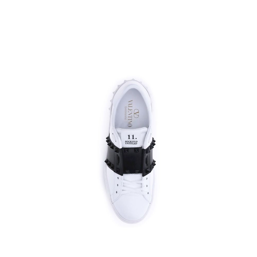Indulge in the exquisite craftsmanship of Valentino Garavani's White Calf Leather Bos Taurus Low Top Sneakers, where luxury meets bold elegance for the discerning individual.