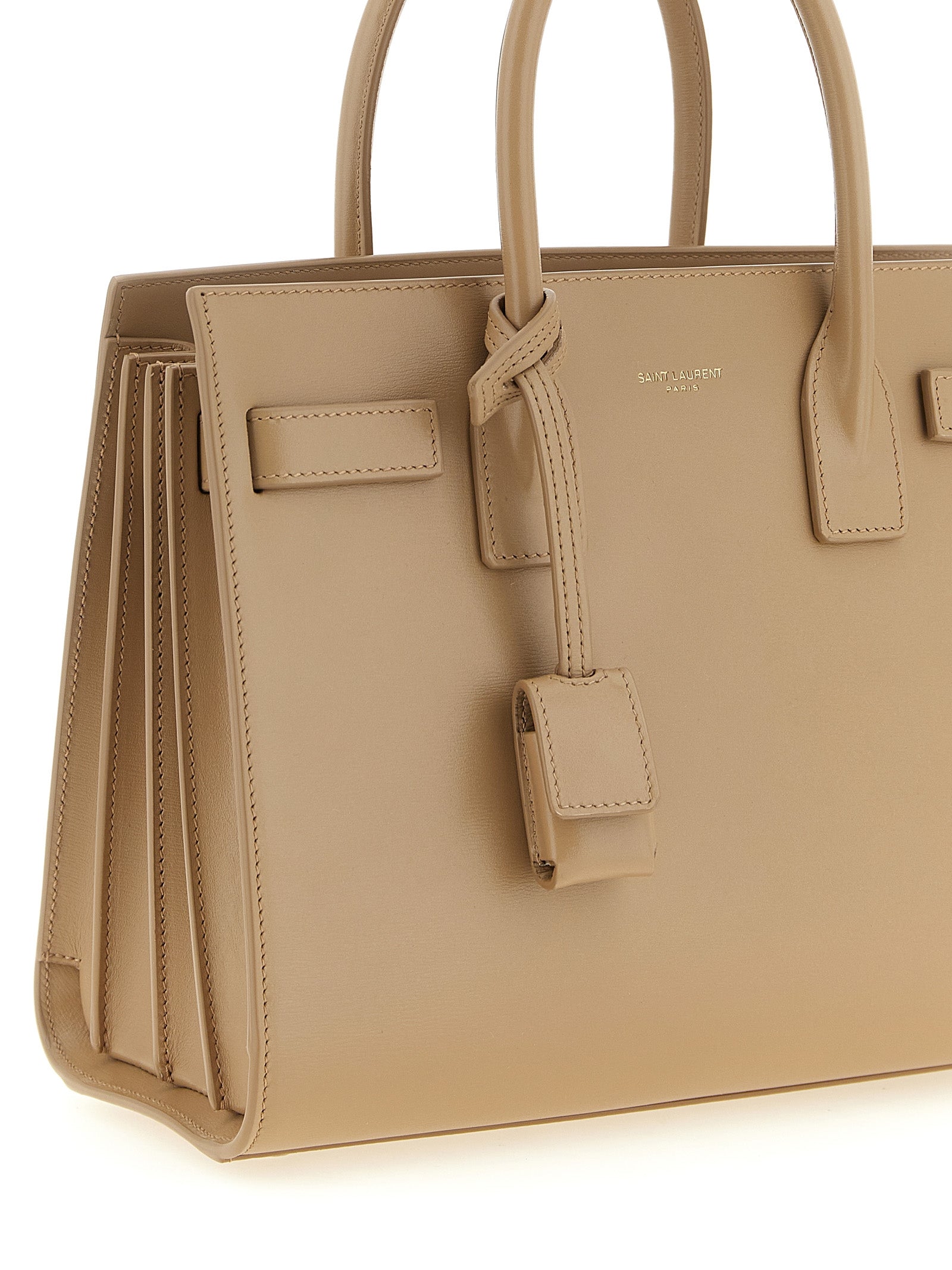 Discover the exquisite Saint Laurent Beige Calfskin Handbag, a timeless masterpiece crafted from luxurious calfskin leather, embodying sophistication and elegance for every occasion.