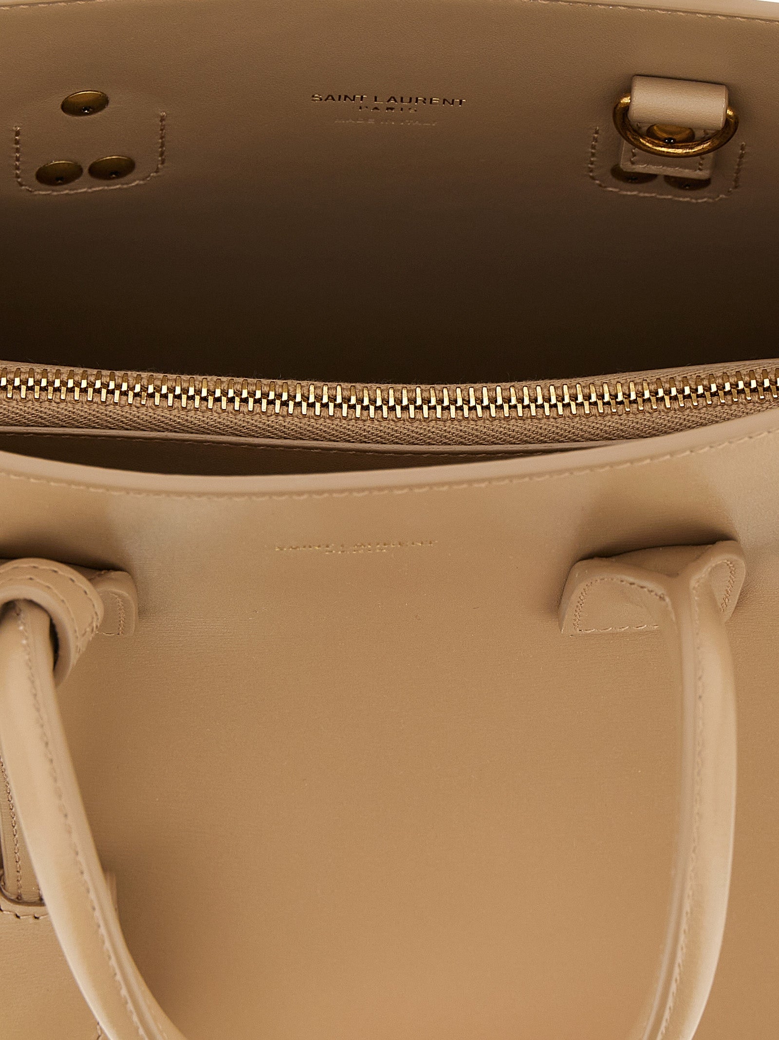 Discover the exquisite Saint Laurent Beige Calfskin Handbag, a testament to Italian craftsmanship and timeless elegance, perfect for the discerning individual.
