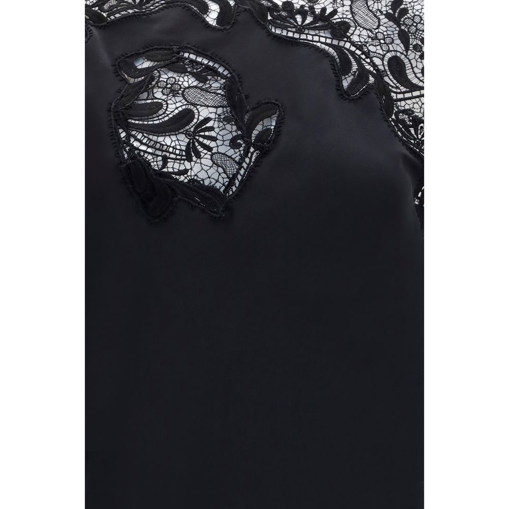Experience the allure of the Ferragamo Black Silk Cocktail Dress, a masterpiece of expert craftsmanship in pure silk, redefining luxury elegance for unforgettable moments.