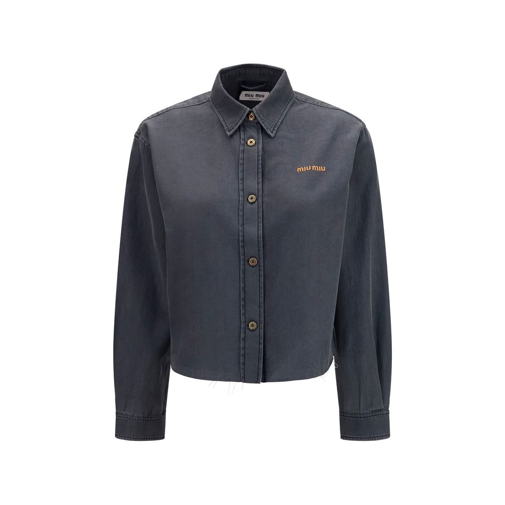 Elevate your wardrobe with the Miu Miu Gray Denim Shirt, a luxurious blend of comfort and sophistication, perfect for the discerning individual seeking timeless elegance.