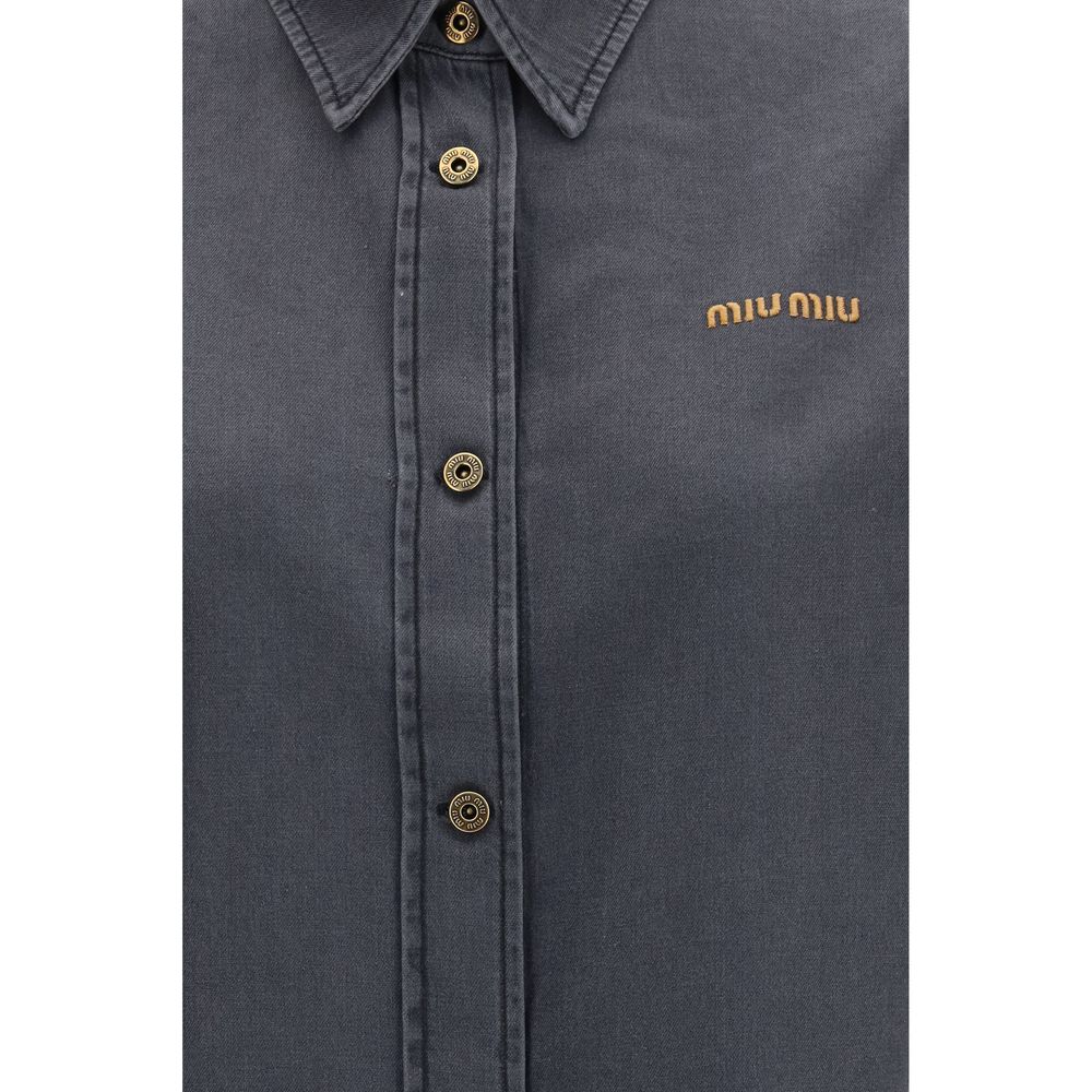 Discover the Miu Miu Gray Denim Shirt, a luxurious blend of denim-effect cotton and sophisticated design, perfect for those who embrace elegance and individuality.