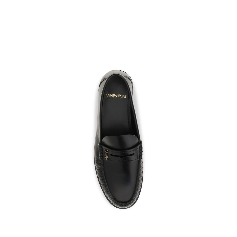 Indulge in the exquisite Saint Laurent Black Calf Leather Bos Taurus Slip-On Loafers, where artisanal craftsmanship meets timeless elegance, perfect for the discerning individual.