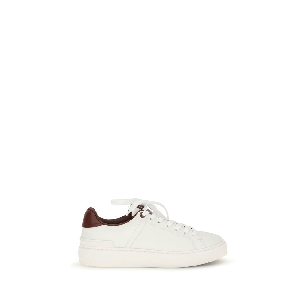 Indulge in the exquisite craftsmanship of Balmain White Calf Leather Bos Taurus Athletic Sneakers, where luxury meets sport, elevating your style with every step.