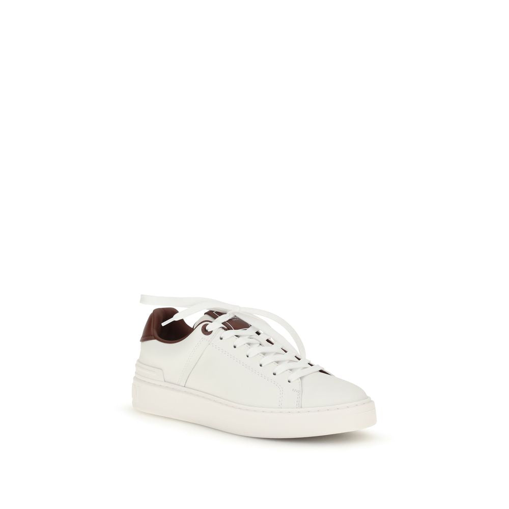 Indulge in the exquisite craftsmanship of Balmain White Calf Leather Bos Taurus Athletic Sneakers, where luxury meets athletic elegance, perfect for the discerning fashion connoisseur.