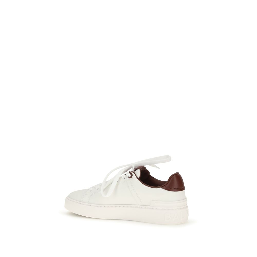 Elevate your style with Balmain White Calf Leather Bos Taurus Athletic Sneakers, where exquisite craftsmanship meets luxurious comfort for the discerning individual.