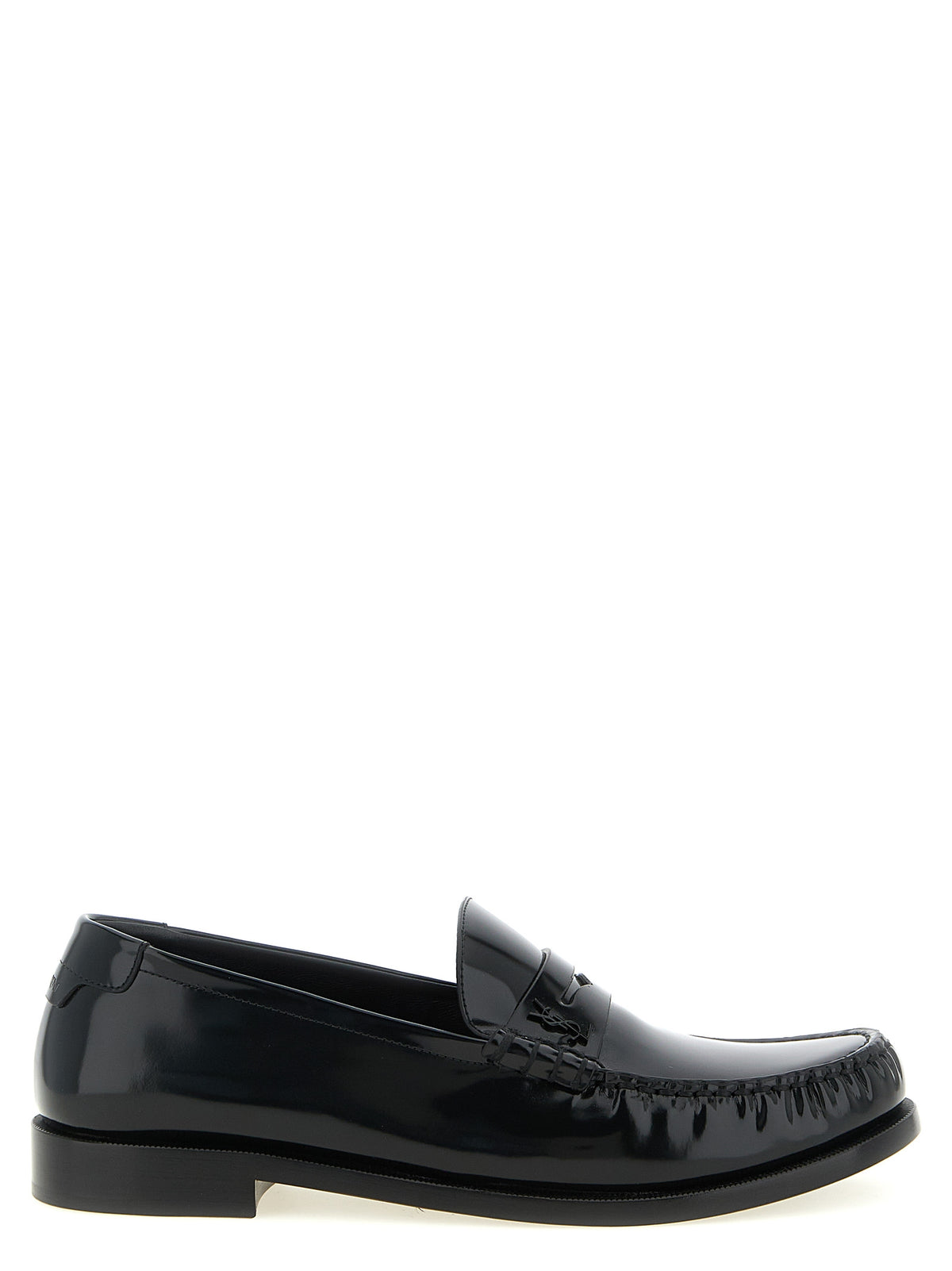 Elevate your style with Saint Laurent's Black Calfskin Slip-On Loafers, a testament to Italian craftsmanship and timeless elegance, perfect for the discerning modern individual.