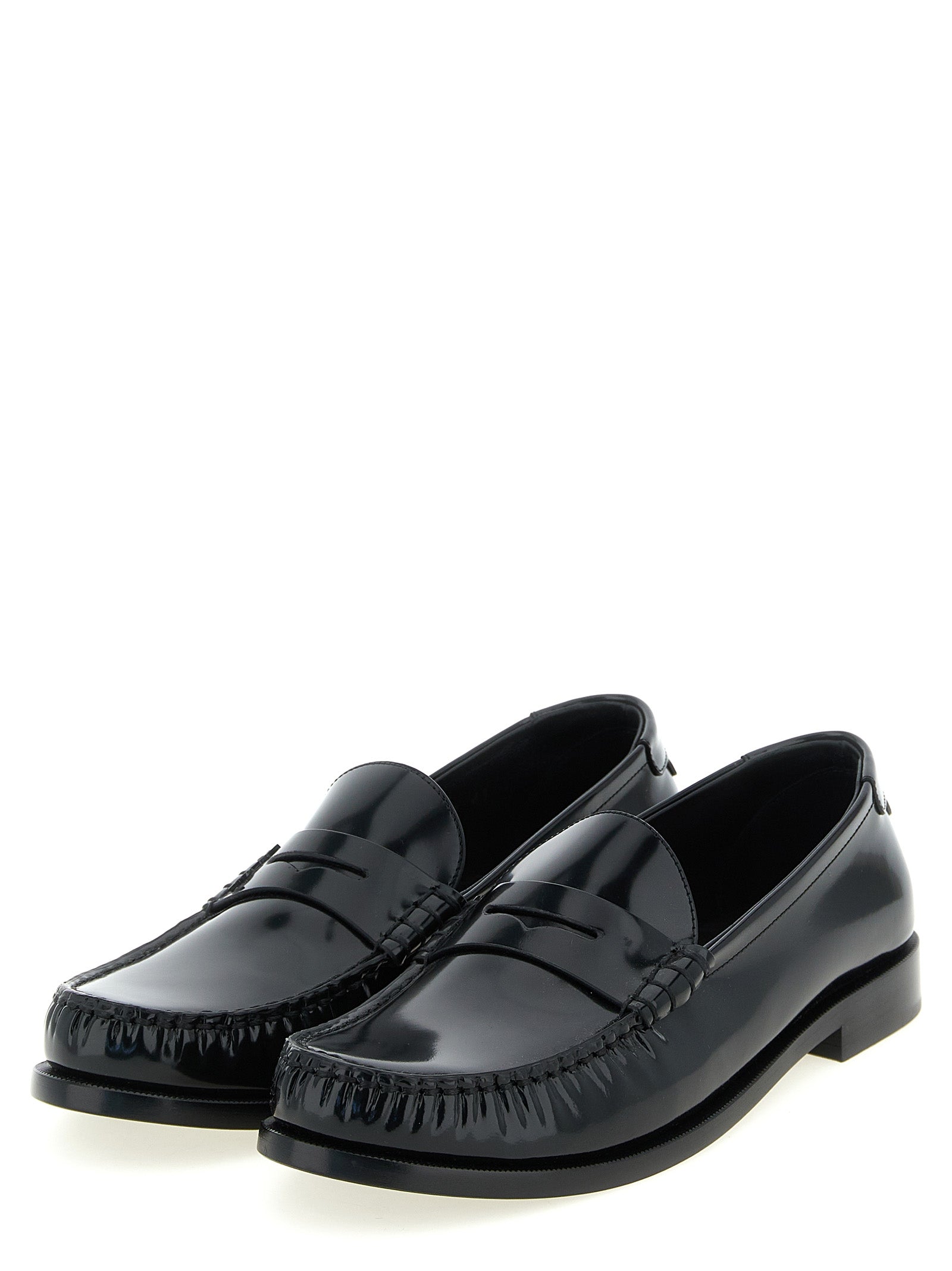 Experience the allure of Saint Laurent's Black Calfskin Slip-On Loafers, where Italian craftsmanship meets modern elegance, perfect for the discerning connoisseur.