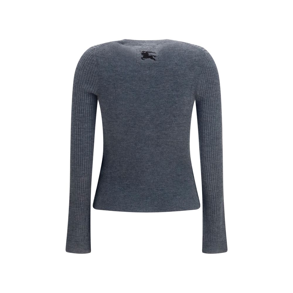 Discover the Burberry Gray Cashmere Cardigan, a masterpiece of 100% cashmere, embodying timeless elegance and sophisticated luxury for the discerning individual.