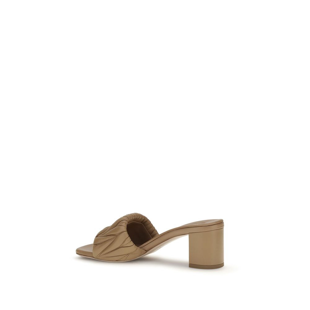 Indulge in the Miu Miu Beige Lamb Ovis Aries Aries Platform Sandals, where sumptuous lambskin meets exquisite craftsmanship, creating a statement of refined elegance for every occasion.