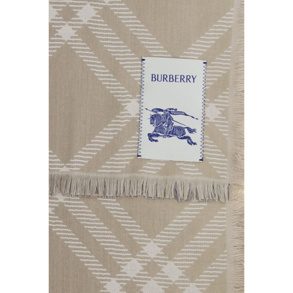 Indulge in the exquisite Burberry Beige Wool Oves Aries Scarf, a luxurious blend of wool and silk, embodying timeless elegance and sophisticated artistry for discerning tastes.