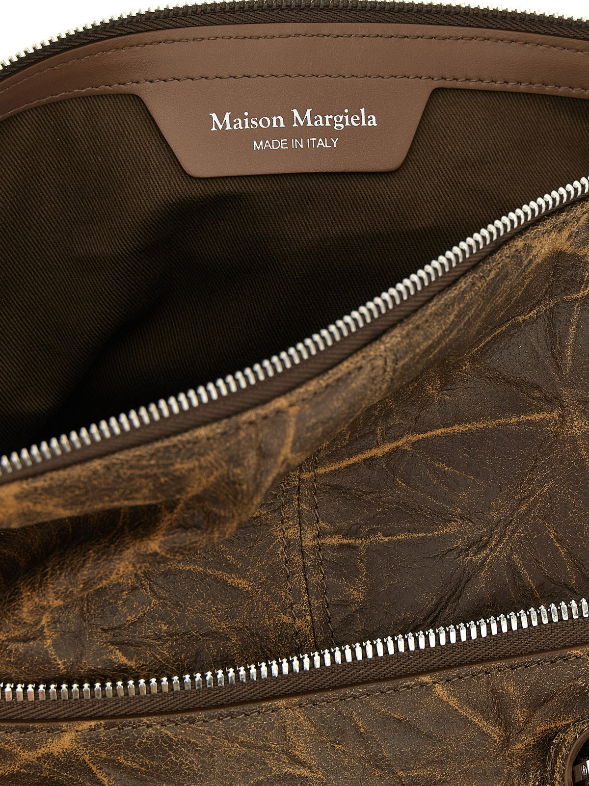 Indulge in the Maison Margiela Brown Goatskin Shoulder Bag, a testament to exquisite craftsmanship and timeless elegance, perfect for the discerning individual.