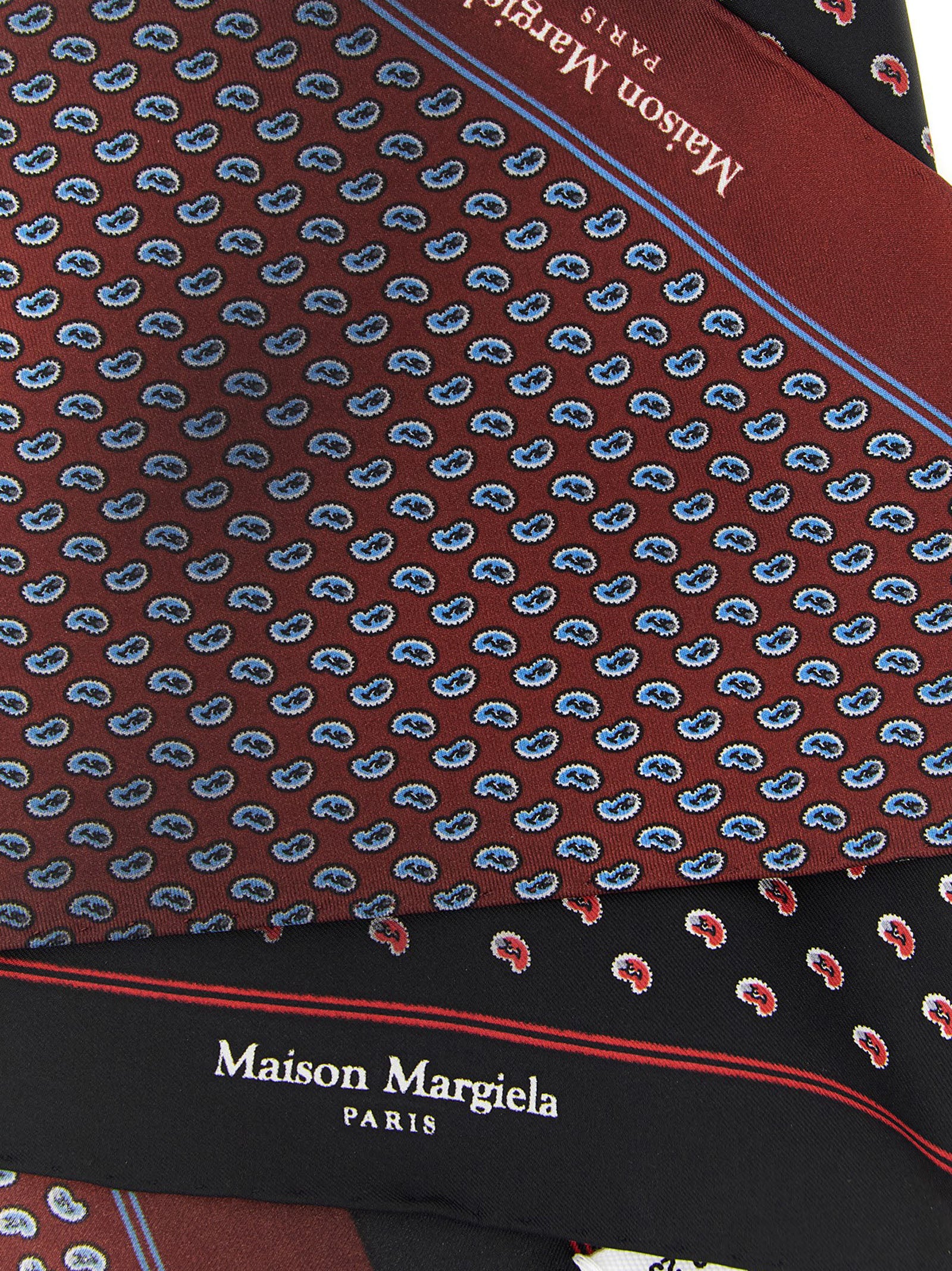 Indulge in the Maison Margiela Multicolor Silk Scarf, a masterpiece of Italian craftsmanship in pure silk, embodying timeless elegance and versatile luxury for the discerning individual.