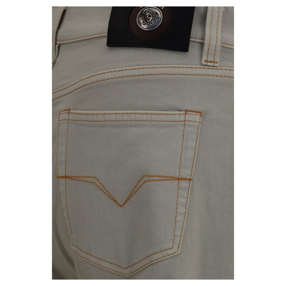 Indulge in the opulence of Versace's Beige Cotton Tapered Jeans, crafted from premium materials for a sophisticated silhouette that elevates your style and confidence.