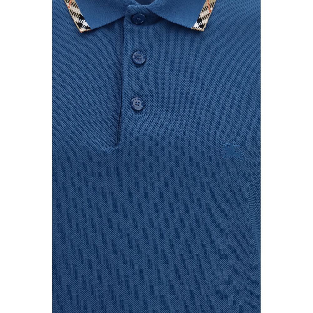 Indulge in the Burberry Blue Cotton Polo Shirt, a masterpiece of 100% cotton craftsmanship, blending timeless elegance with modern sophistication for the discerning individual.