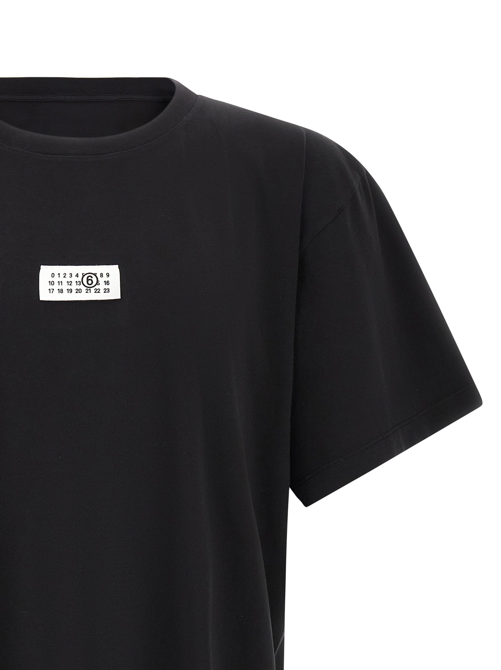 Discover the MM6 Maison Margiela Black Cotton T-Shirt, a luxurious blend of minimalist design and exquisite craftsmanship, perfect for effortless elegance in any setting.