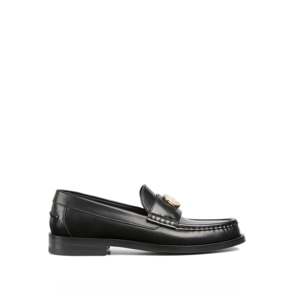 Discover the Gucci Black Leather Slip-On Loafers, a masterpiece of Italian craftsmanship, where luxurious leather meets timeless elegance for the discerning individual.