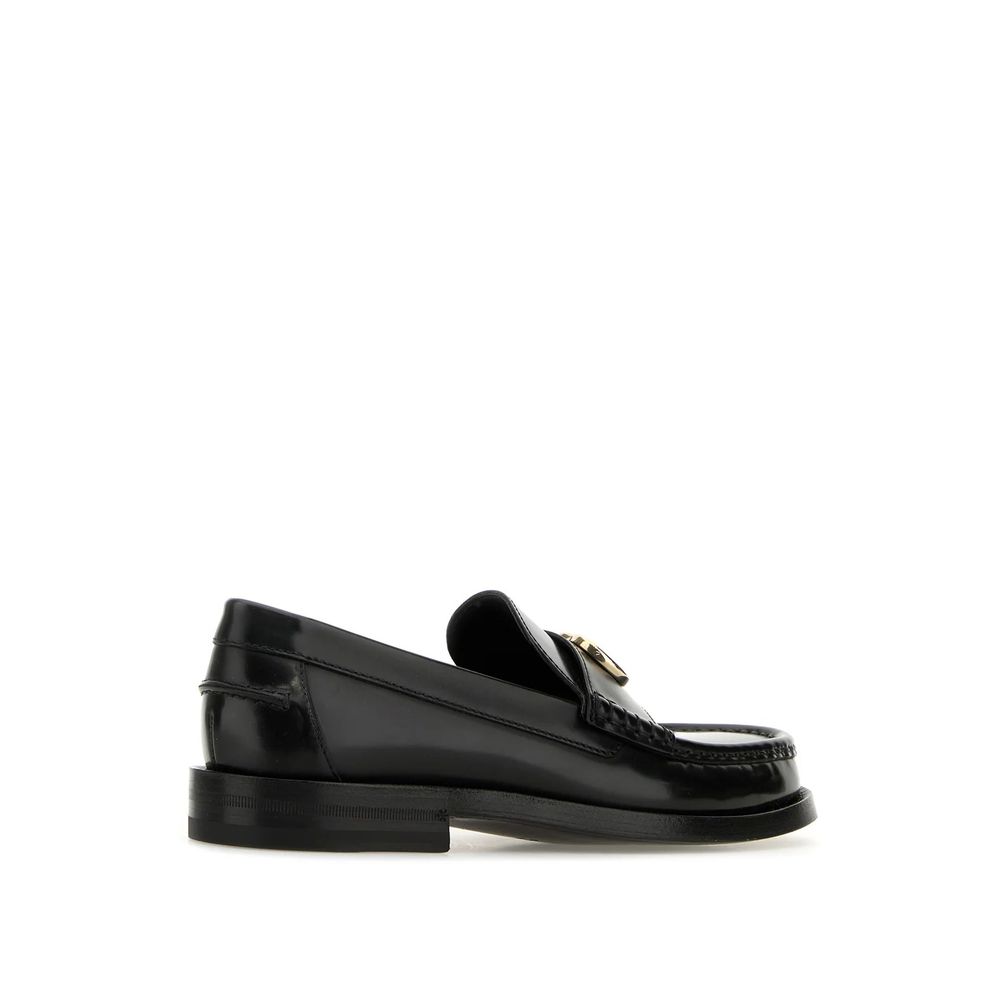 Experience the allure of Gucci Black Leather Slip-On Loafers, crafted from premium leather with iconic gold-tone detailing, embodying timeless elegance for the discerning individual.